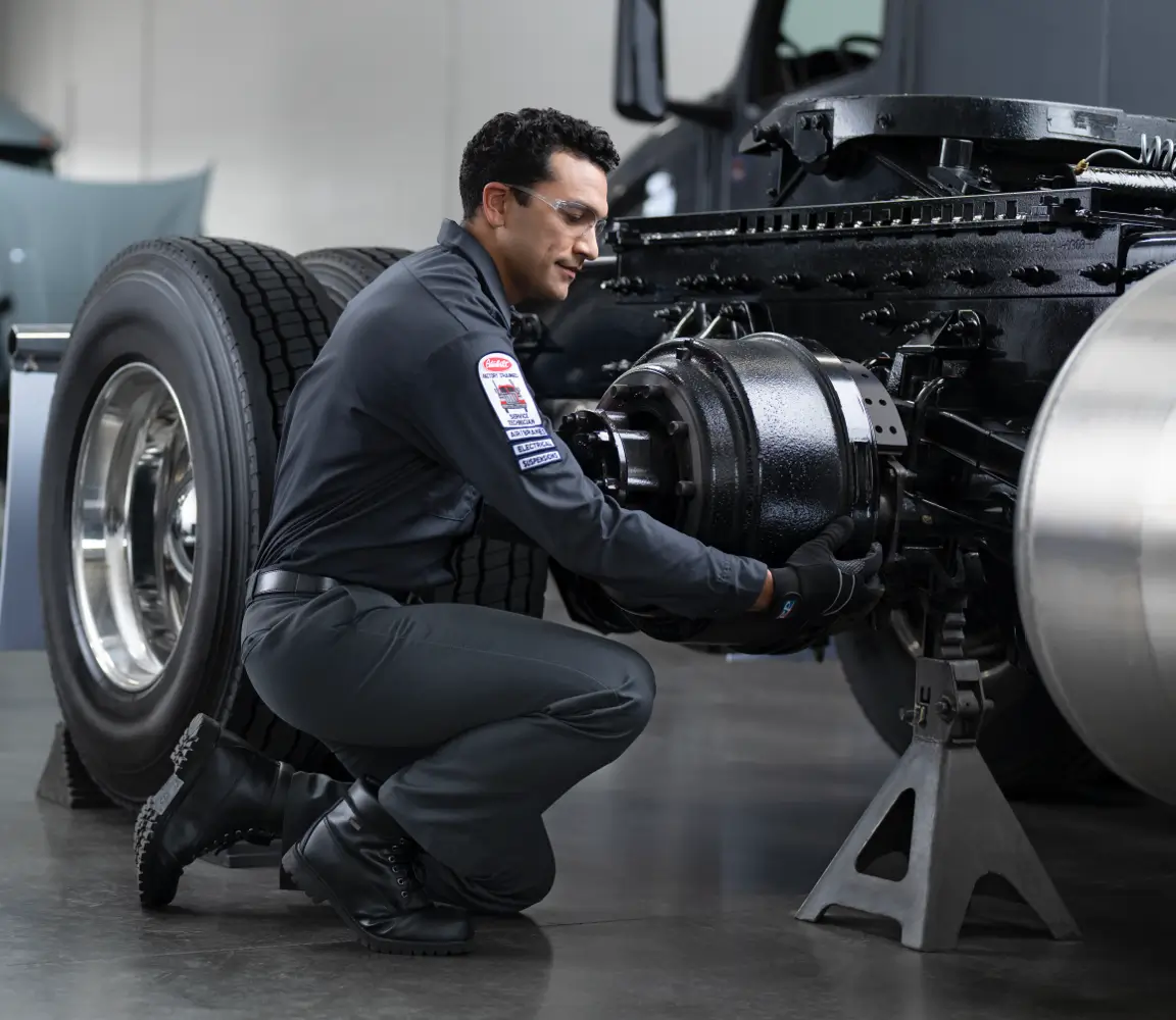 A Peterbilt technician services a truck